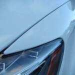 Before and after photographs of a damaged white, AUDI Quattro SUV that was repaired by Elite Paint & Body Shop in West Palm Beach, Florida.